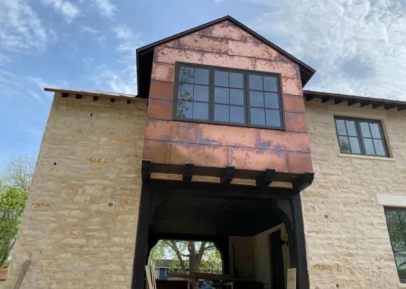 Copper metal panel facade on a stone building for Metal Roof Coating in Kaser