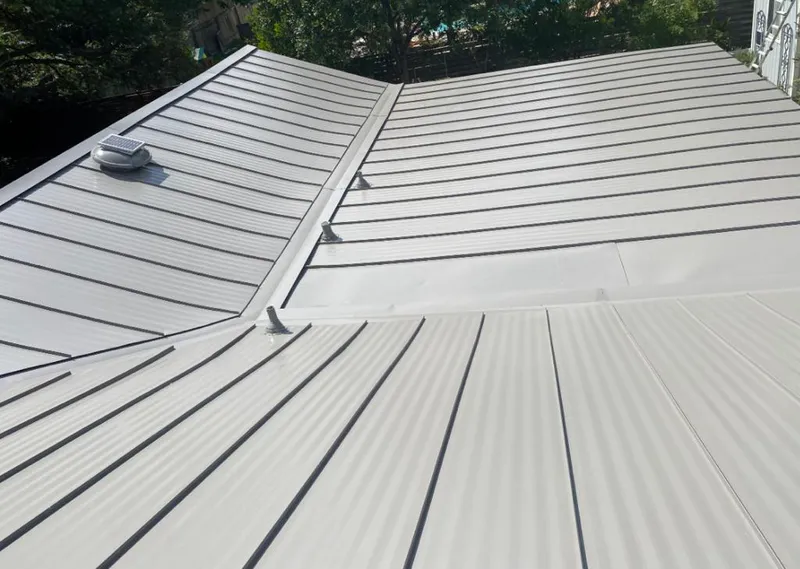 Solar attic fan installed on a metal roof for Roof Ventilation in Kaser